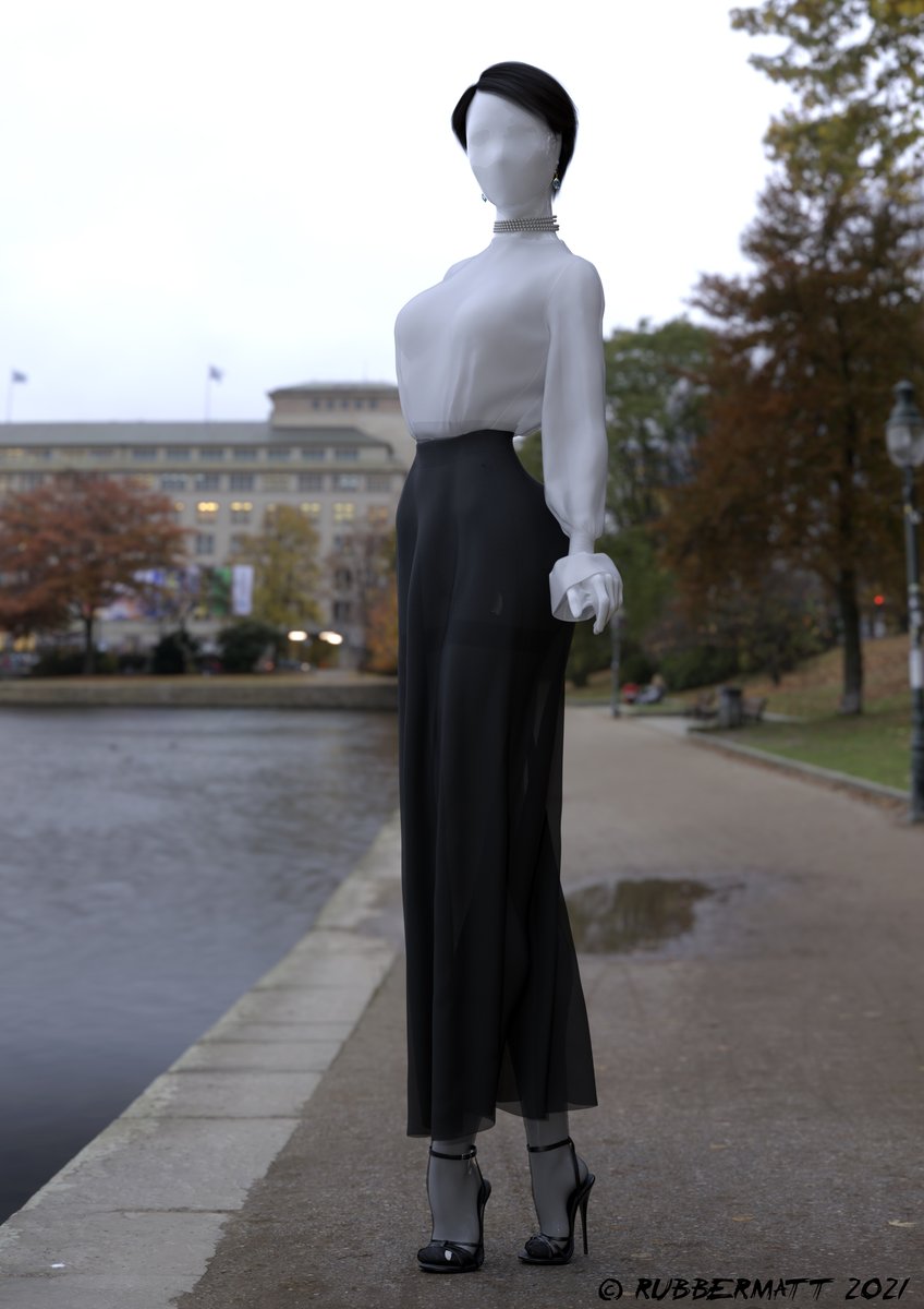 Brunette with a long skirt at the lakeside